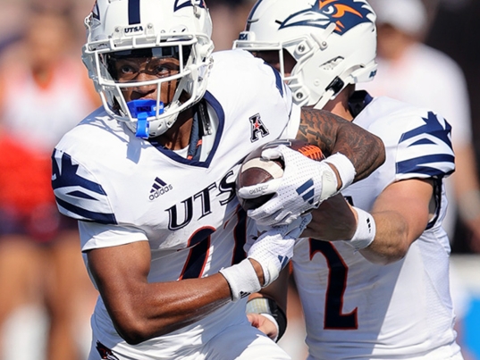 A closely cropped image of two football players.
